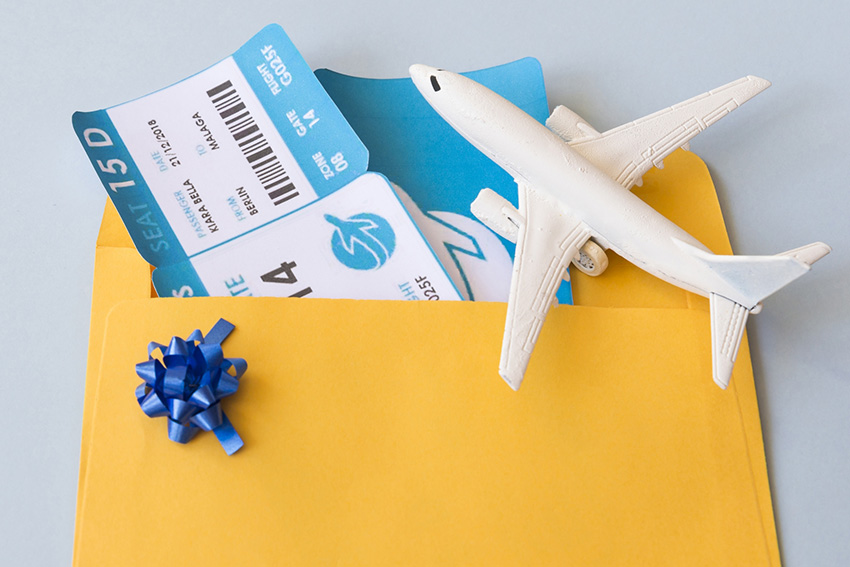 airplane-tickets-document-case-near-toy-aircraft